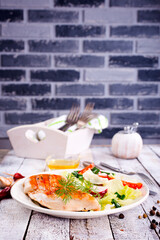 Grilled chicken breast, fillet and fresh vegetable salad of lettuce, arugula, spinach, cucumber and tomato.