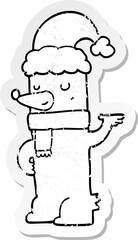 distressed sticker of a cartoon bear wearing christmas hat