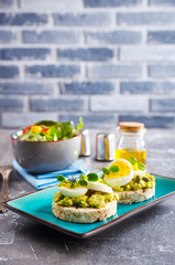 Healthy tasty toast with avocado, white cheese and boiled egg on plate