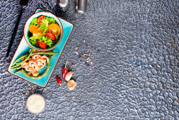 Healthy salad plate. Fresh seafood recipe. Grilled shrimps and fresh vegetable salad.
