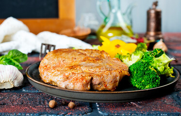 steak with onions and cherry tomatoes. Juicy steak with flavored butter