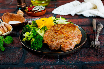 steak with onions and cherry tomatoes. Juicy steak with flavored butter