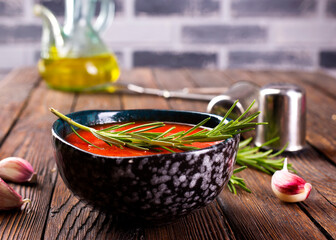 traditional spanish cold soup puree gaspacho or gazpachoon a dark background.