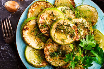 Sliced spiced zucchini with oil, salt and garlic