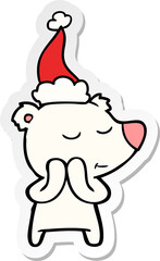 happy hand drawn sticker cartoon of a polar bear wearing santa hat