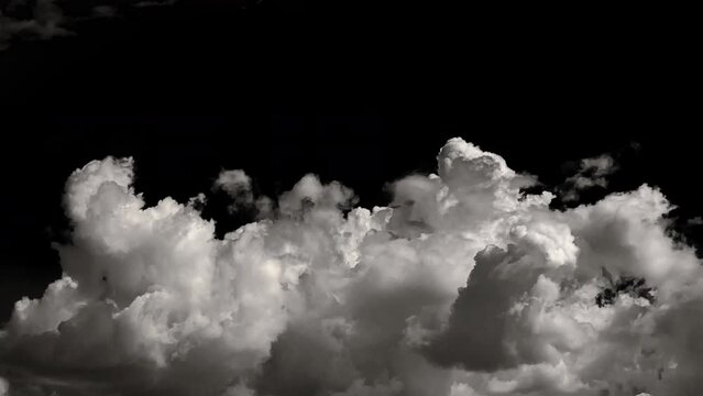 time-lapse of separate white clouds on a black background have real clouds. time-lapse of White cloud isolated on a black background realistic cloud. time-lapse of white fluffy cumulus cloud isolated