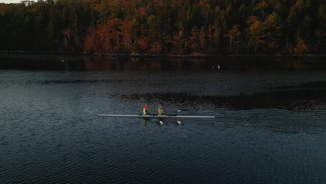White rowing boat in motion with two women, aerial view. Canada, Halifax.
