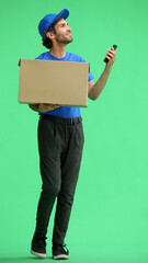 full-length male courier holding a box on a green background