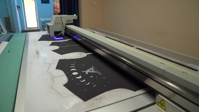 Plotter printing. Printing services and printing. The plotter prints the image.