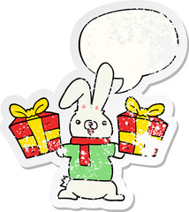cartoon rabbit with christmas presents with speech bubble distressed distressed old sticker