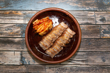 Kimchi, a traditional Korean fermented food. A plate of boiled pork served with traditional kimchi.