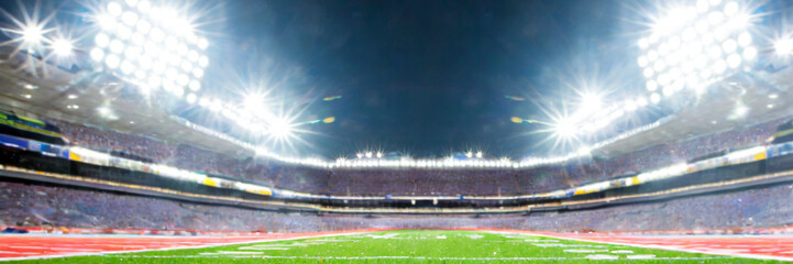 Football field illuminated by stadium lights. Sports background