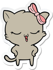 sticker of a cartoon cat with bow on head and hands on hips