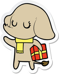 sticker of a cute cartoon elephant with gift