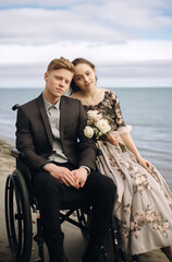 Fototapeta premium happy couple with a wheelchair,Disabilities-specific content