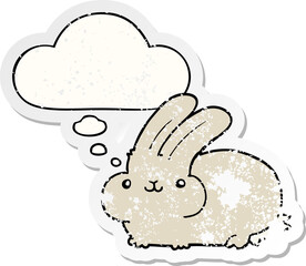 cartoon rabbit with thought bubble as a distressed worn sticker