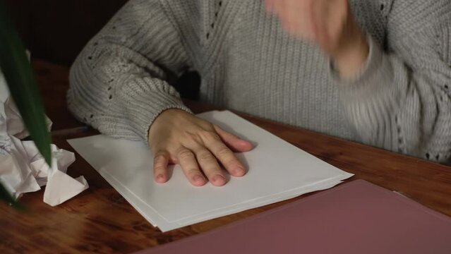 Creative crisis concept. Female writer crumples paper sheets.