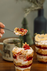 Christmas trifle in a glass glass with fruit filling.