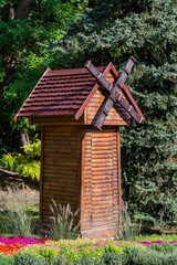 A small wooden decorative mill to decorate city park in Kyiv, Ukraine, closeup. Ecology and environment concept