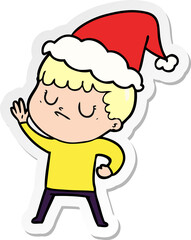 hand drawn sticker cartoon of a grumpy boy wearing santa hat