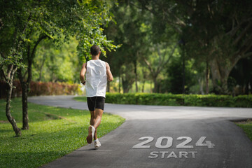 Sport man running at park garden. Start into the new year 2024. Start up of runner woman running on...