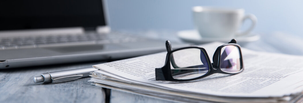 glasses on newspaper on table