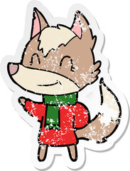 distressed sticker of a friendly cartoon wolf in winter clothes