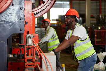 African factory workers or engineer using the machine in the factory