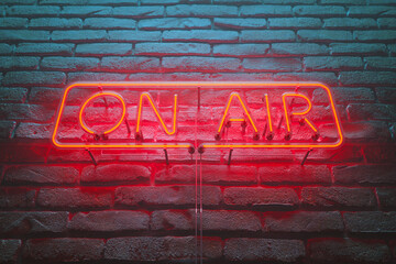 Bright 'On Air' Neon Light Sign Casting Glow on Dark Brick Wall