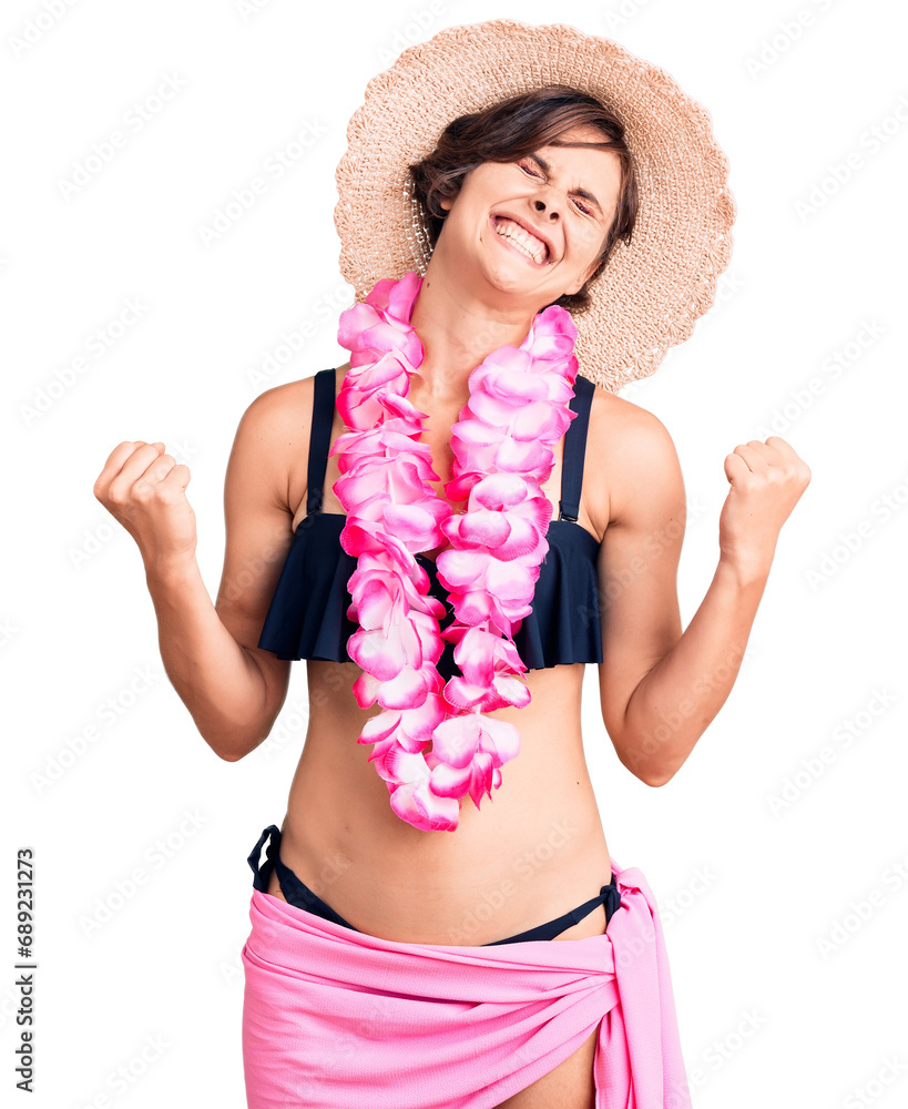 Sticker beautiful young woman with short hair wearing bikini and hawaiian lei very happy and excited doing w