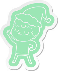 quirky cartoon  sticker of a grumpy boy wearing santa hat