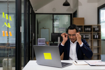 Asian businessman working at a desk business financial technology financial documents and business...