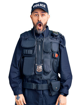Young handsome man wearing police uniform afraid and shocked with surprise and amazed expression, fear and excited face.