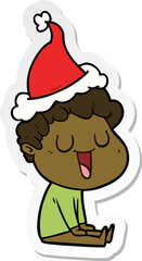 laughing hand drawn sticker cartoon of a man wearing santa hat