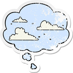 cartoon clouds with thought bubble as a distressed worn sticker