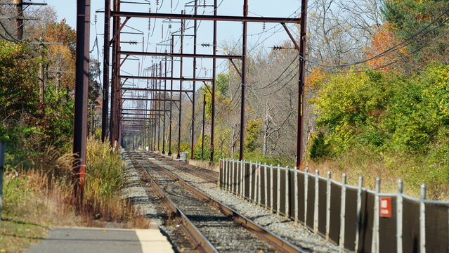 The railroad view with the parallel iron tracks and platform as background