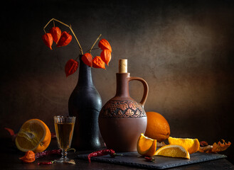 Still life with an autumn bouquet and oranges on a dark background