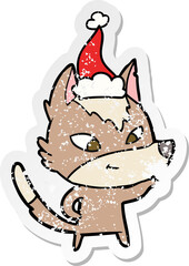 friendly hand drawn distressed sticker cartoon of a wolf wearing santa hat