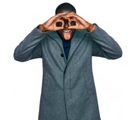 Young african american man wearing business clothes and glasses doing ok gesture like binoculars sticking tongue out, eyes looking through fingers. crazy expression.