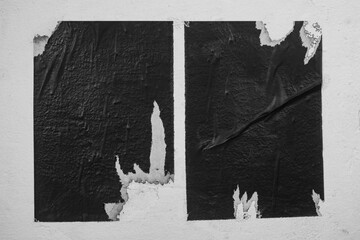 Scraps of two black posters on a white background.