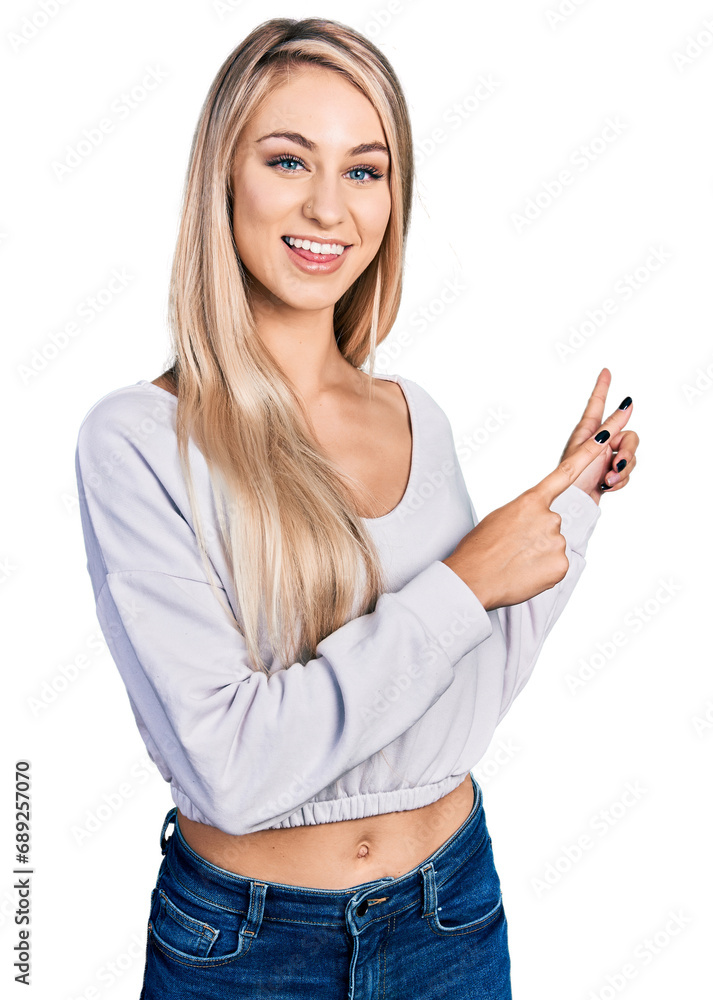 Sticker Beautiful young blonde woman wearing casual white sweater smiling and looking at the camera pointing with two hands and fingers to the side.