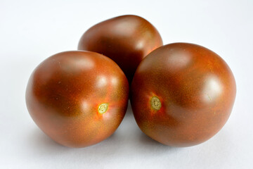 group of kumato tomatoes isolated on white background