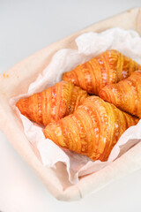 Crispy croissants in wicker basket