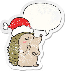 cartoon hedgehog wearing christmas hat with speech bubble distressed distressed old sticker