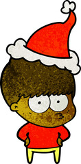 nervous hand drawn textured cartoon of a boy wearing santa hat