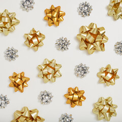 Golden and silver decorative gift bows on a white background