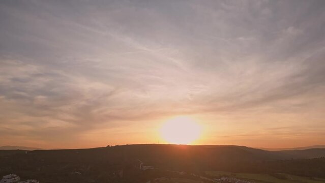 Establishing aerial flying over residential urbanisation neighbourhood. Residential single family houses, lush greenery, beautiful sunset view. Costa del Sol, Spain