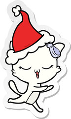 hand drawn sticker cartoon of a cat with bow on head wearing santa hat