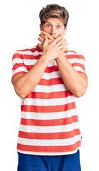 Young handsome man wearing casual clothes shocked covering mouth with hands for mistake. secret concept.