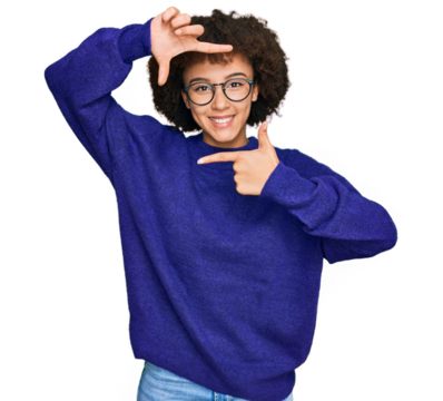 Young hispanic girl wearing casual winter sweater and glasses smiling making frame with hands and fingers with happy face. creativity and photography concept.
